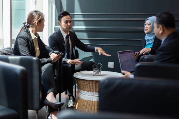 Group of business man discuss about strategy in the lounge area at co-working space.